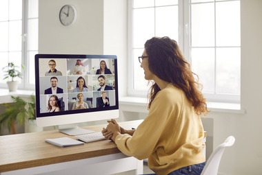 Woman on virtual call with multiple employees